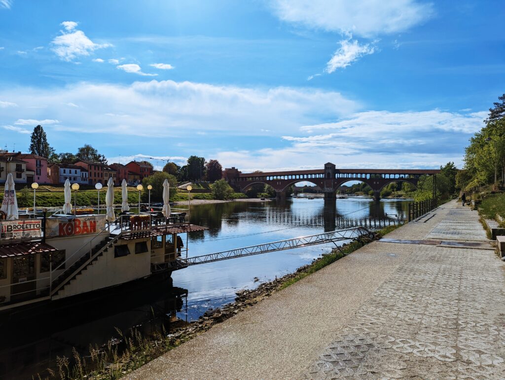 Po River in Pavia with Ponte Coperto in the background and a ship in the foreground