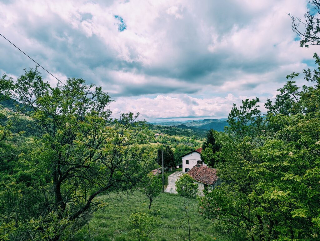 Looking over the Apennines southward, dark, clouds mountain to the horizon and a farm hous in the foreground