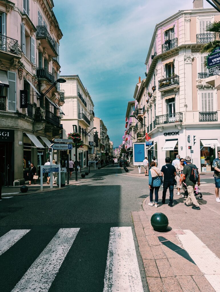 View of street in Cannes, France with people on the streets and many stores