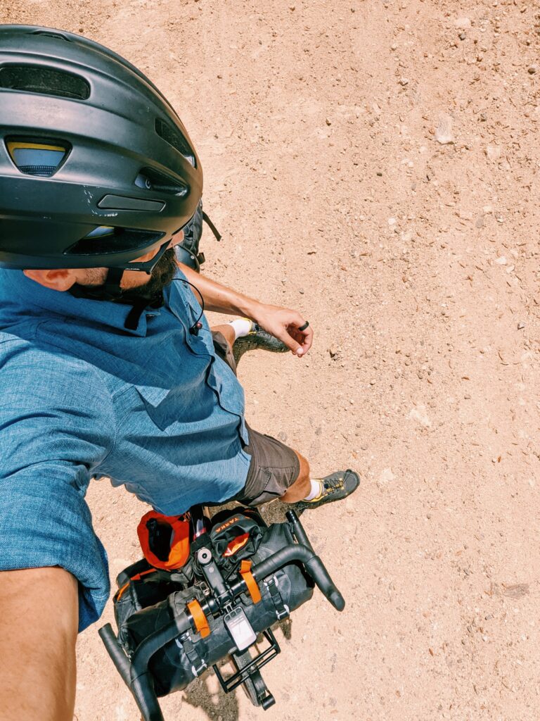 Selfie taken overhead, showing my helmet and bike on a dirt road