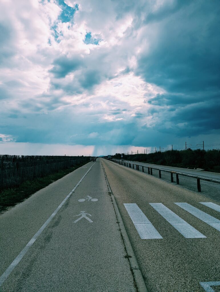 Bike path heading west with dark clouds in the back