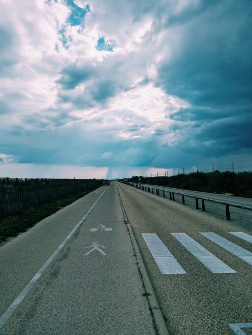Bike path heading west with dark clouds in the back