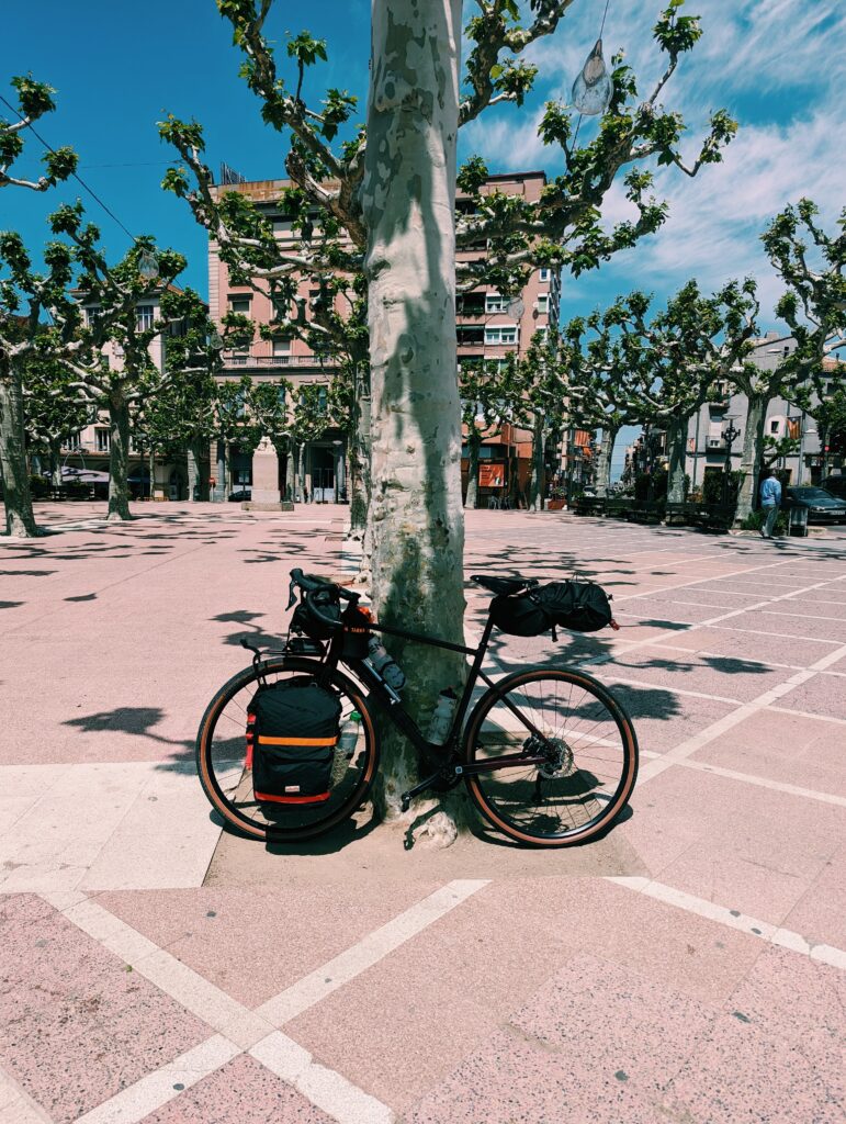 My bike perched against a tree in the Plaça d'Anselm Clavé in Tàrrega