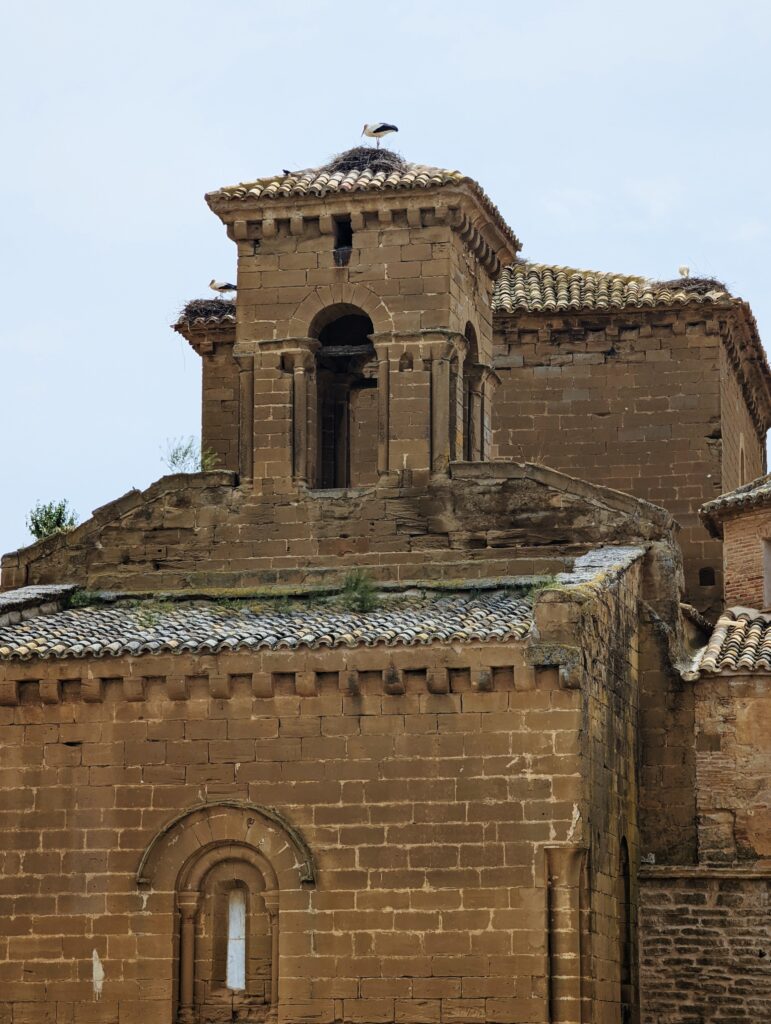 Steeple of Real Monasterio de Santa María de Sigena with three stork's nests on top