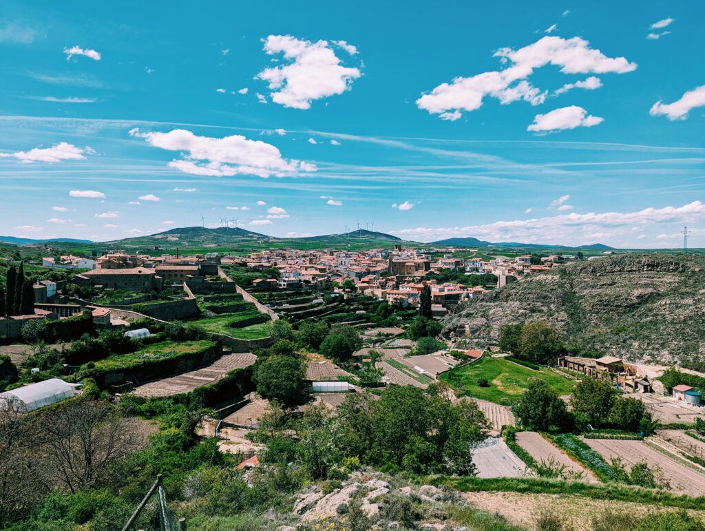 View of the town of Ágreda form above; terrace gardens in the foreground, blue skies