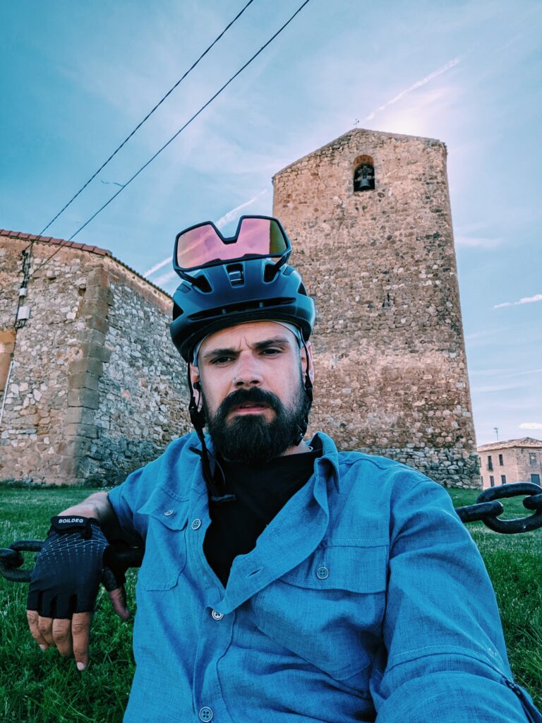 Me exhausted sitting on the lawn in front of the church in Aldealpozo