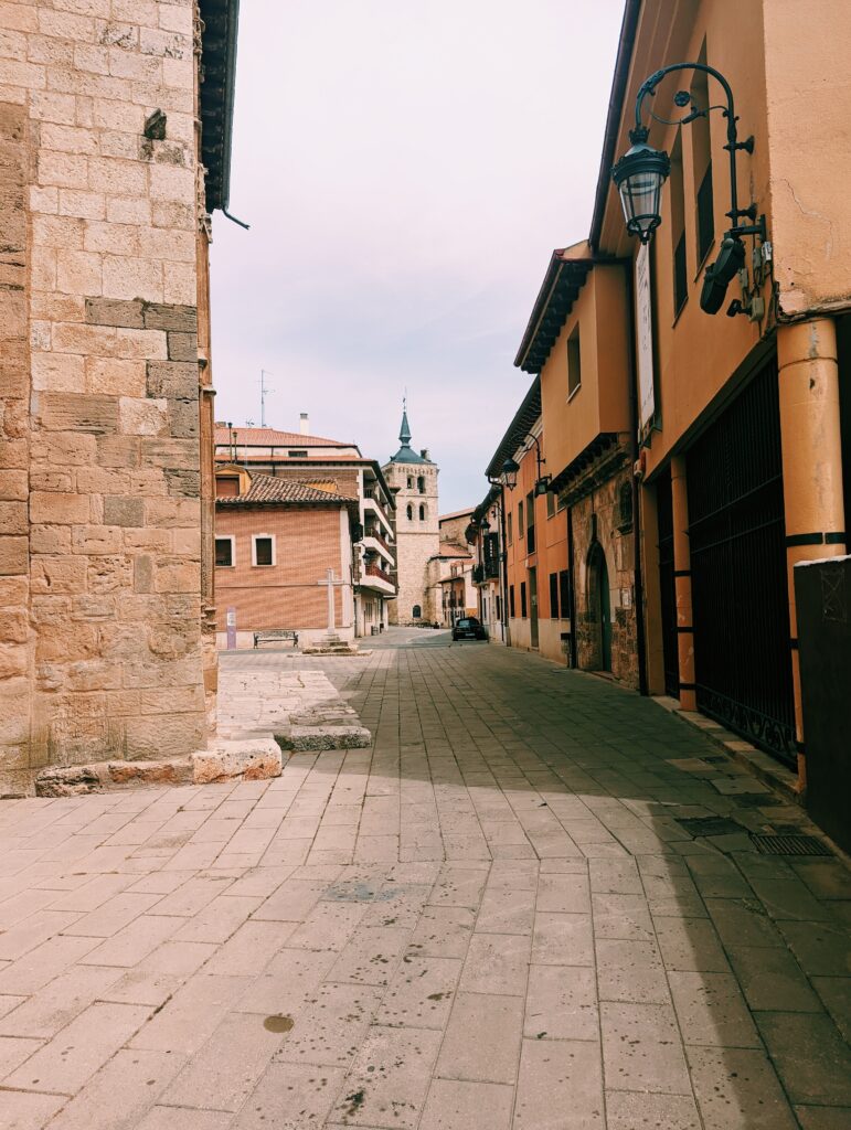 View down a narrow street in Aranda de Duero, church steeple at the end of the road
