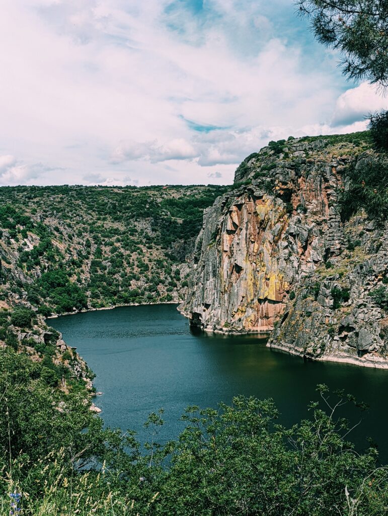 A bend in Douro River with colorful cliffs rocky cliffs showing on the Spanish side of the border