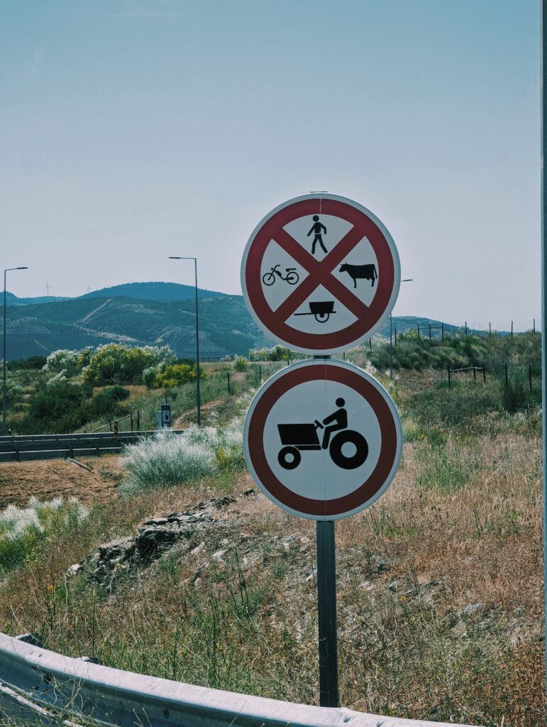 Signs on a road in Portugal. The upper prohibitng pedestrians, moped, carts or livestock the lower prohbiting tractors