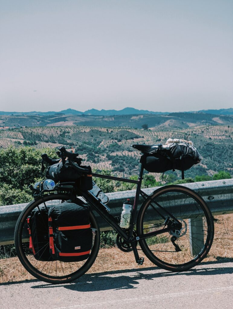 My bike leaned against a guard railing in the back vast lookout into Terras de Trás-os-Montes