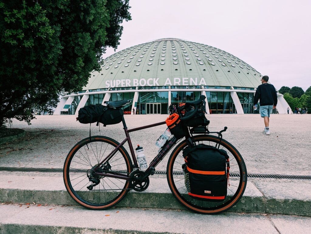 Bike standing on stairs in front of the Super Bock Arena in Porto